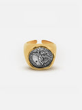 Tactilery Angel Coin Ring in polished gold displayed on a white background, the large round coin medallion face with engraved classical angel relief and rope-twist border on a smooth polished gold band
