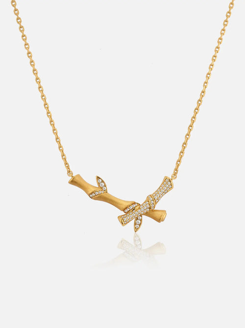 Tactilery Bamboo Whisper Necklace in polished gold on a white background, the pendant formed by three hollow cylindrical bamboo-segment tubes of graduating height — the tallest center tube flanked by two shorter tubes — each tube with a smooth polished gold surface and raised horizontal joint rings at top and bottom, the three tubes joined side by side, suspended from a fine polished gold twisted rope chain with a lobster clasp and oval tag charm extension chain