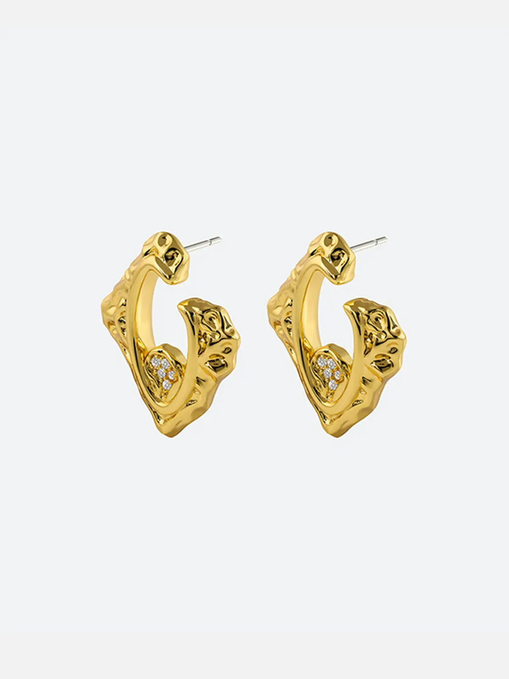 Pair of Tactilery Baroque Frame Stud Earrings in polished gold on a white background, both shown face-on displaying the full angular diamond-shaped C-hoop form with heavily textured molten baroque surface, open center frame, and pavé zircon quatrefoil accent at the lower inner corner, with silver post pins visible at top