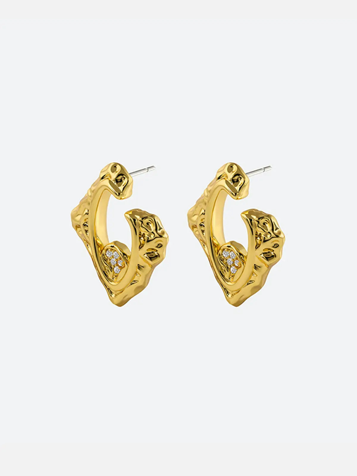 Pair of Tactilery Baroque Frame Stud Earrings in polished gold on a white background, both shown face-on displaying the full angular diamond-shaped C-hoop form with heavily textured molten baroque surface, open center frame, and pavé zircon quatrefoil accent at the lower inner corner, with silver post pins visible at top