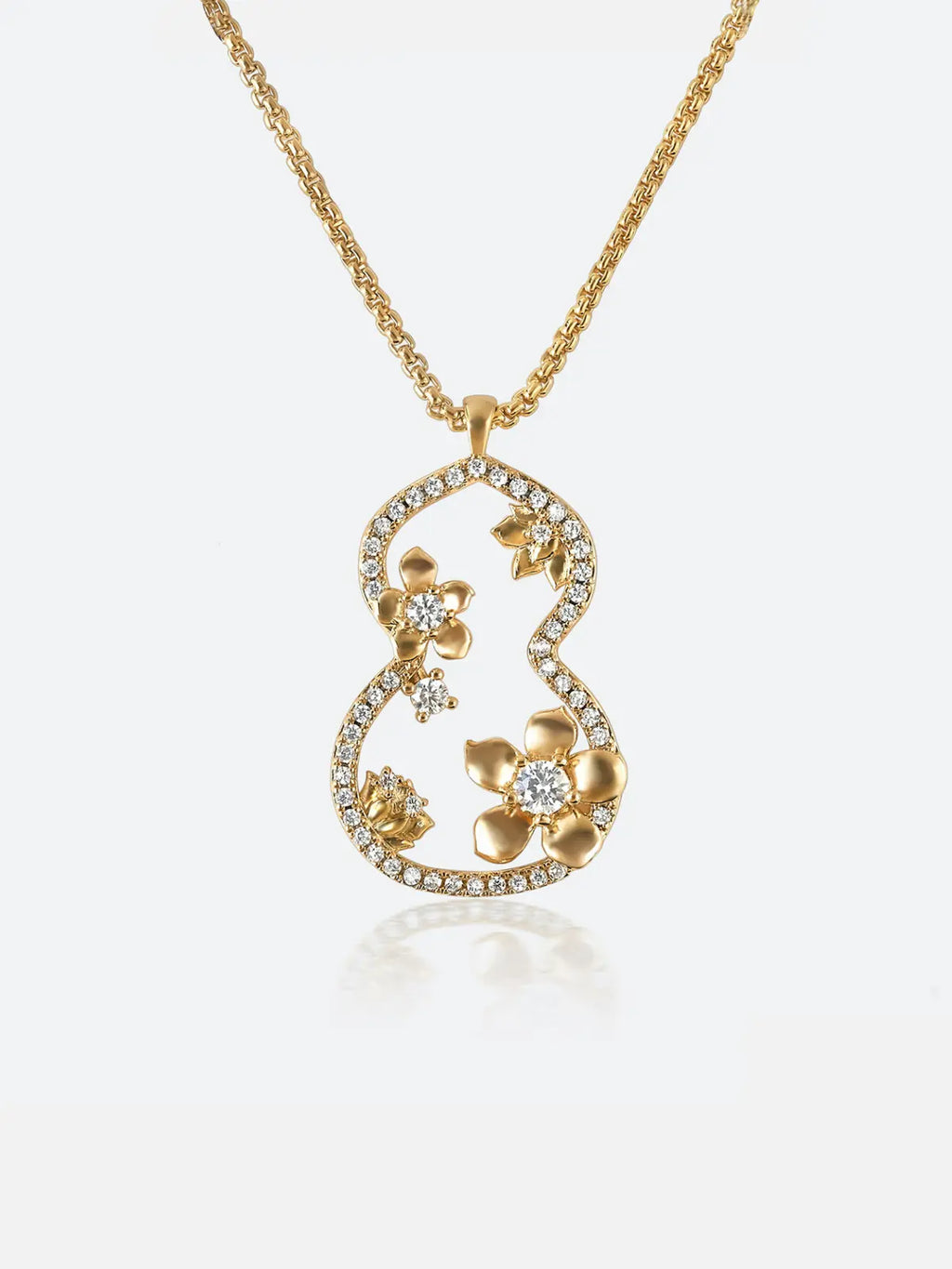 A garden dream gourd window necklace featuring a stylized gourd or gourd shape adorned with small gold flowers and clear stones, suspended from a delicate gold chain against a light gray background.