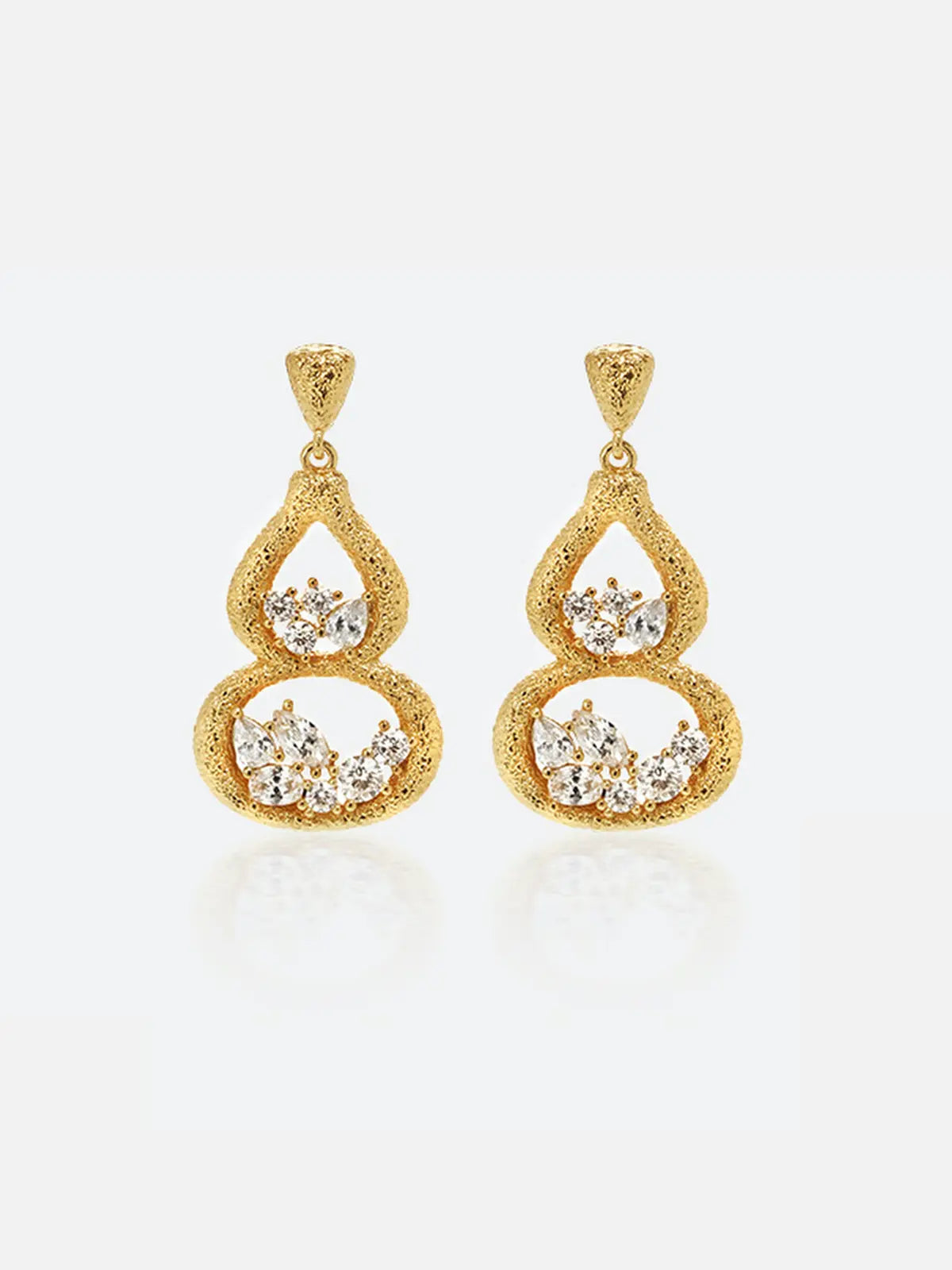 Pair of Tactilery Gourd Texture Stud Earrings in matte brushed gold on a white background, the double-gourd drop stud with heavily sand-textured gold open frame — small teardrop upper chamber and larger oval lower chamber — each chamber holding a prong-set mixed-cut zircon cluster of marquise and round stones, suspended from a textured triangular gold stud top