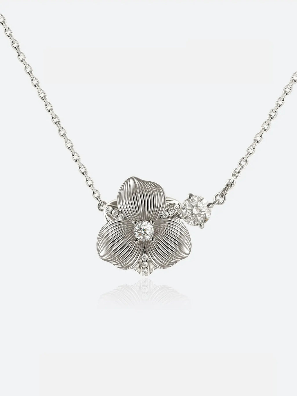 A Tactilery hibiscus flower necklace featuring a textured silver flower pendant with a small clear crystal at its center, displayed against a clean white background.