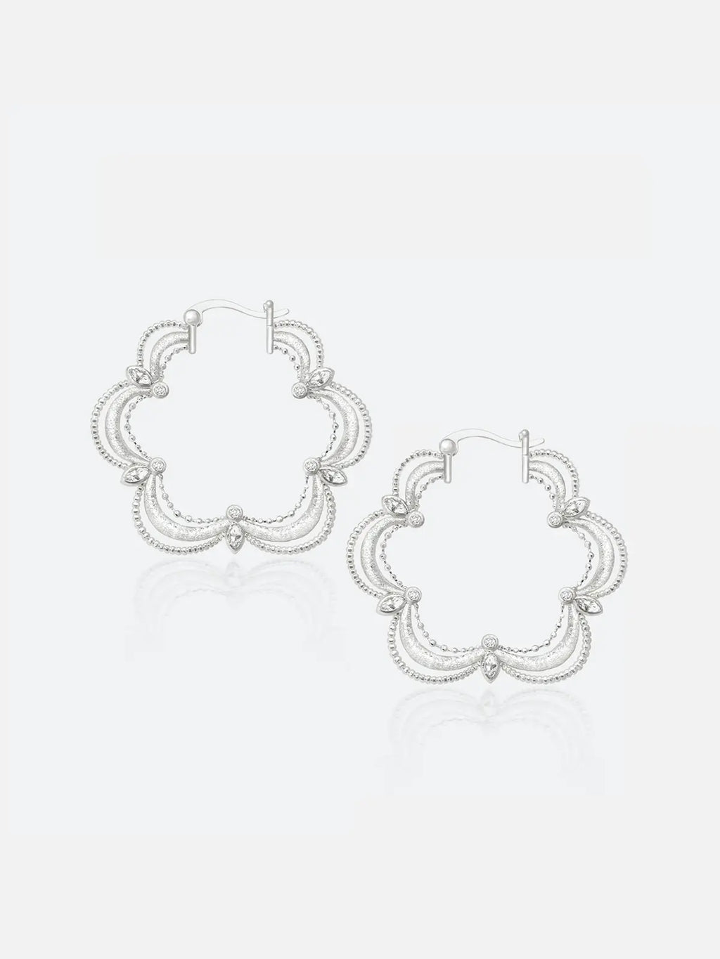 Pair of Tactilery Lace Court Earrings in polished silver on a white background, the large quatrefoil hoop with a scalloped four-lobe silhouette constructed from three concentric polished silver wire arches per lobe edged with fine beaded milgrain borders, prong-set marquise zircon accents at each lobe junction, and a small bezel-set round zircon at the base of each lobe, with hinged hoop post closure at top