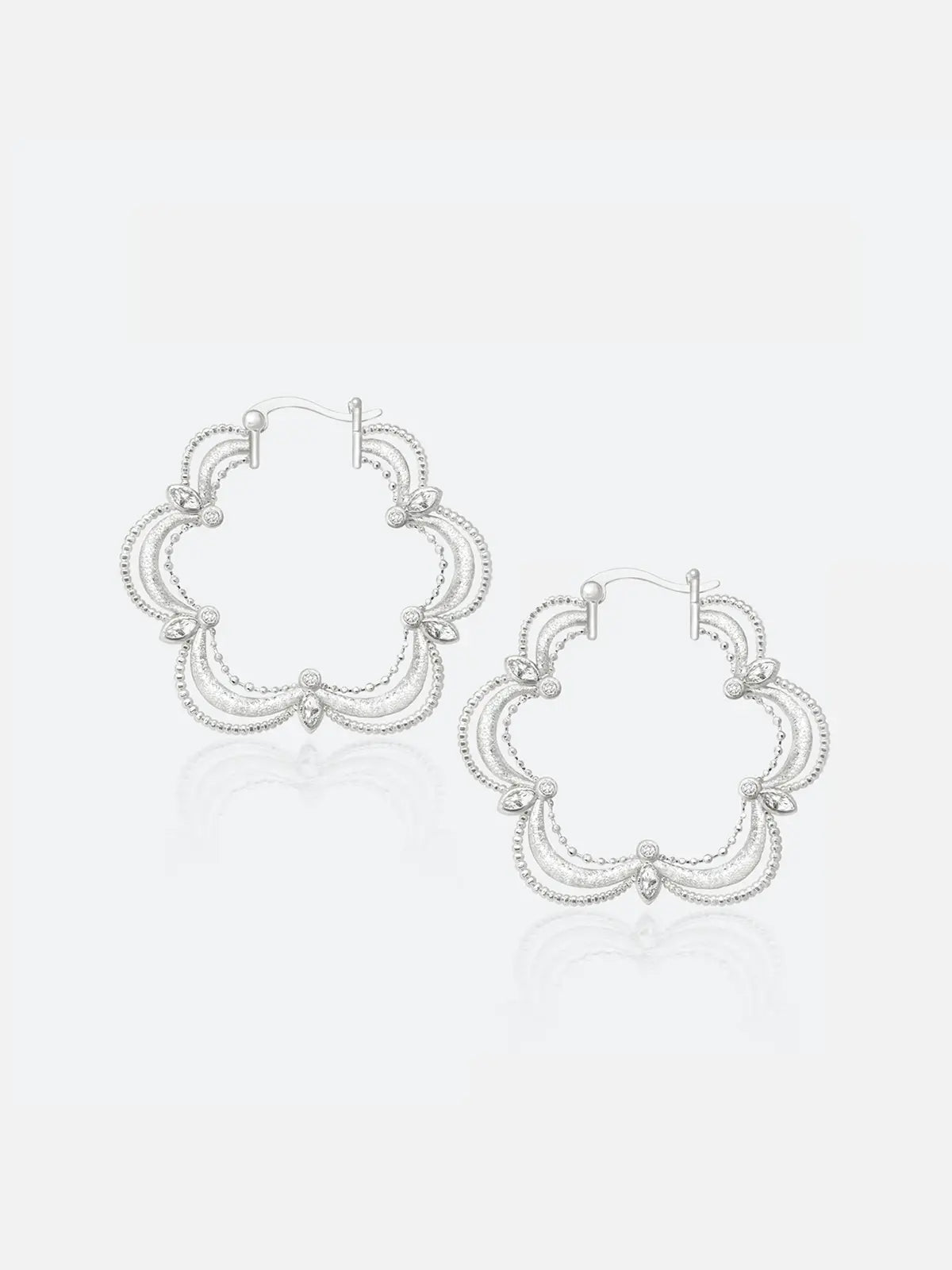 Pair of Tactilery Lace Court Earrings in polished silver on a white background, the large quatrefoil hoop with a scalloped four-lobe silhouette constructed from three concentric polished silver wire arches per lobe edged with fine beaded milgrain borders, prong-set marquise zircon accents at each lobe junction, and a small bezel-set round zircon at the base of each lobe, with hinged hoop post closure at top