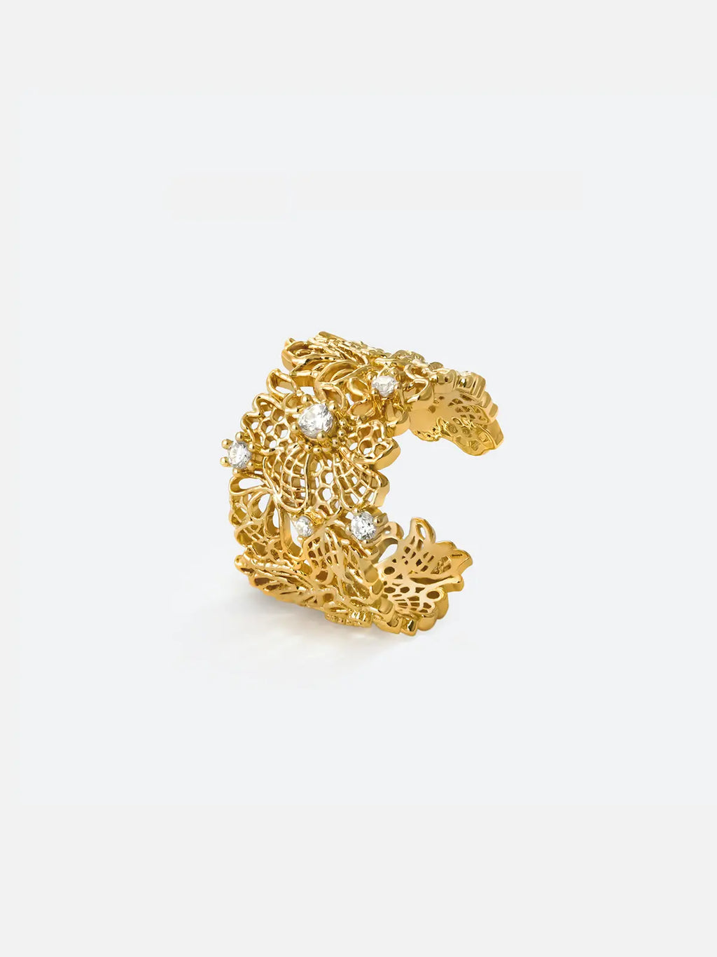 Tactilery Lace Garden Open Ring in polished gold on a white background, the wide open cuff band with intricate openwork lace floral and vine lattice pattern across the full band face, with five prong-set round zircon accents scattered across the openwork surface