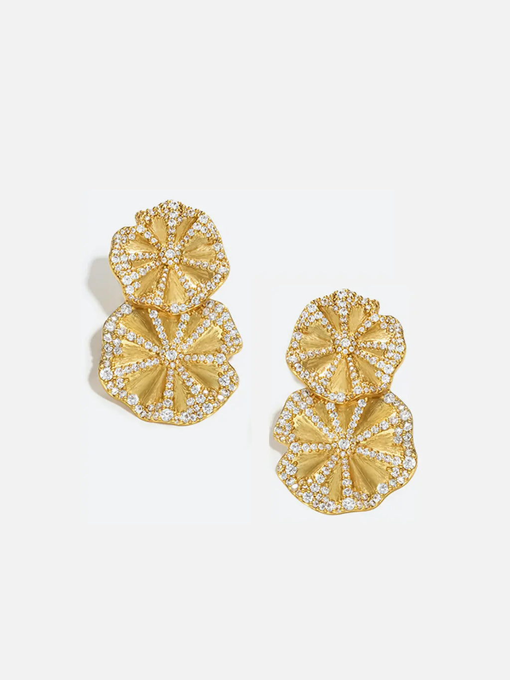Pair of Tactilery Rain Lotus Leaf Stud Earrings in matte brushed gold on a white background, the double lotus leaf drop stud with a smaller scalloped round lotus leaf at top and a larger scalloped round lotus leaf below, each leaf with radiating ribbed vein texture and a fully pavé zircon border edge, suspended from a small pavé zircon square stud top with silver post pins
