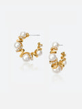 Pair of Tactilery Spiral Twist Pearl Hoop Earrings in polished gold on a light grey background, the large C-hoop constructed from a continuous polished gold spiral twist wire interspersed with five graduated white pearl spheres — small at top, progressively larger toward the bottom — with pavé zircon bar accents at each spiral junction, with silver post pins at top
