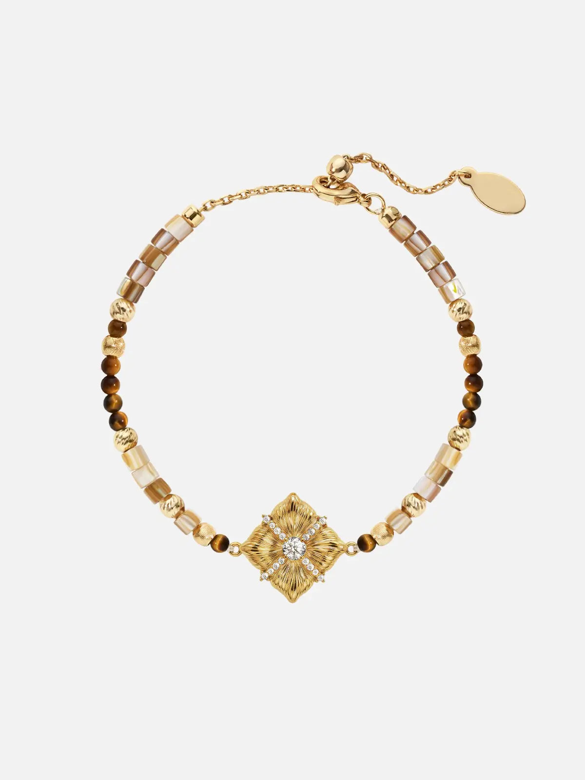 Tactilery Sugar Cube Beaded Bracelet in polished gold on a white background, the beaded bracelet composed of alternating caramel brown tiger eye round beads, translucent grey-brown rectangular tube beads, and polished gold ball spacer beads, centered by a large square diamond-shaped gold pendant with deeply radiating sunburst line-engraved texture, a central prong-set large round zircon, and a pavé zircon cross accent radiating outward, with a polished gold lobster clasp and oval tag charm extension chain