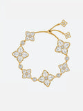 A Tactilery two-tone persimmon calyx bracelet featuring multiple flower motifs paved with clear stones, displayed on a clean light gray background.