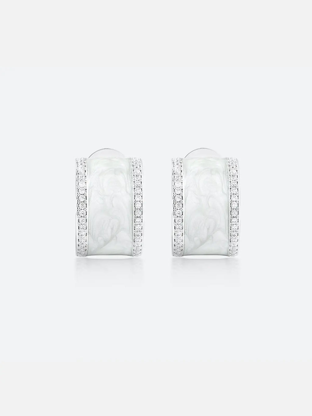 Pair of Tactilery White Glaze Zircon Hoop Earrings displayed face-on on a light grey background, showing the full front face of the wide chunky silver C-hoop with smooth white glaze enamel center panel and two fully pavé zircon rails along the top and bottom edges